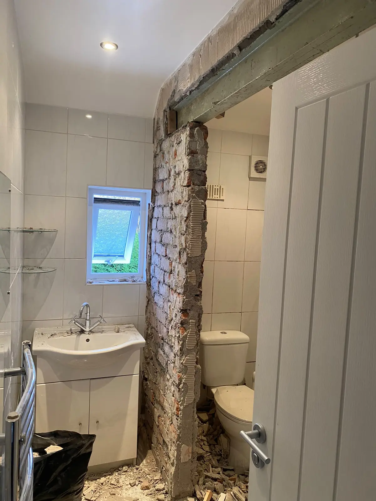 The dividing wall coming down beside the old bathroom suite