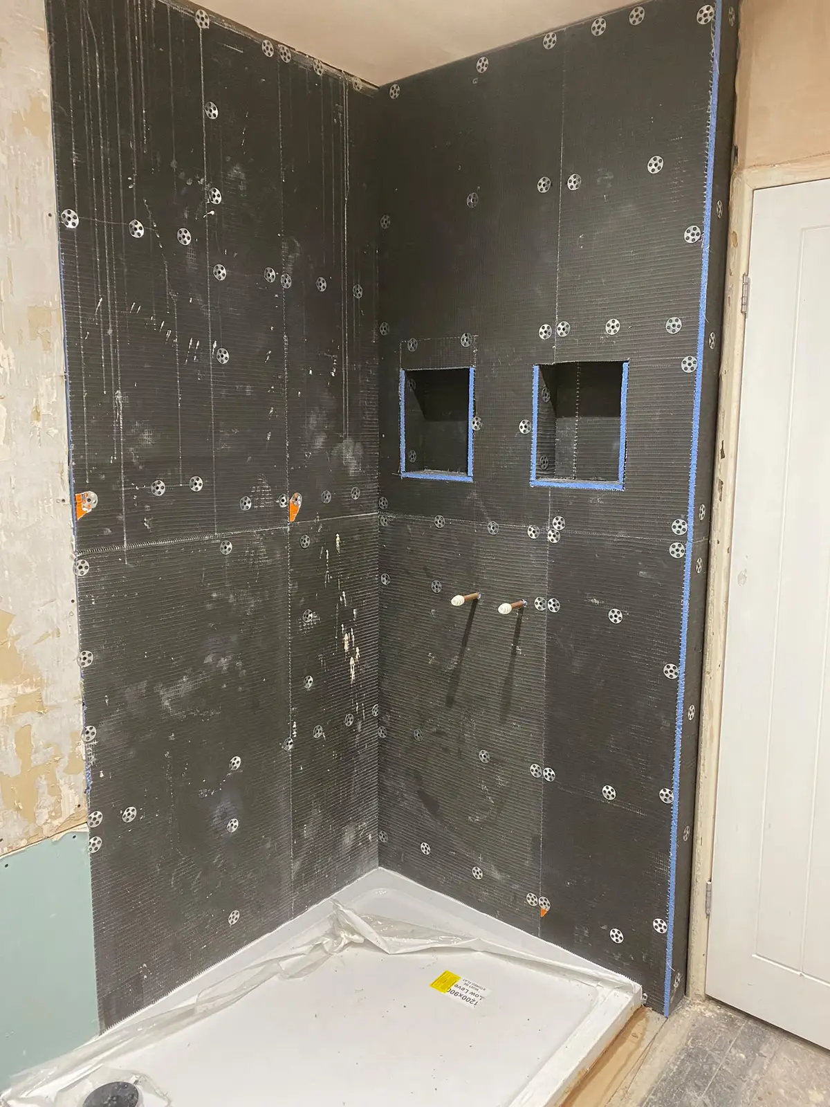 Tile backer boards fitted, with twin alcoves in the shower