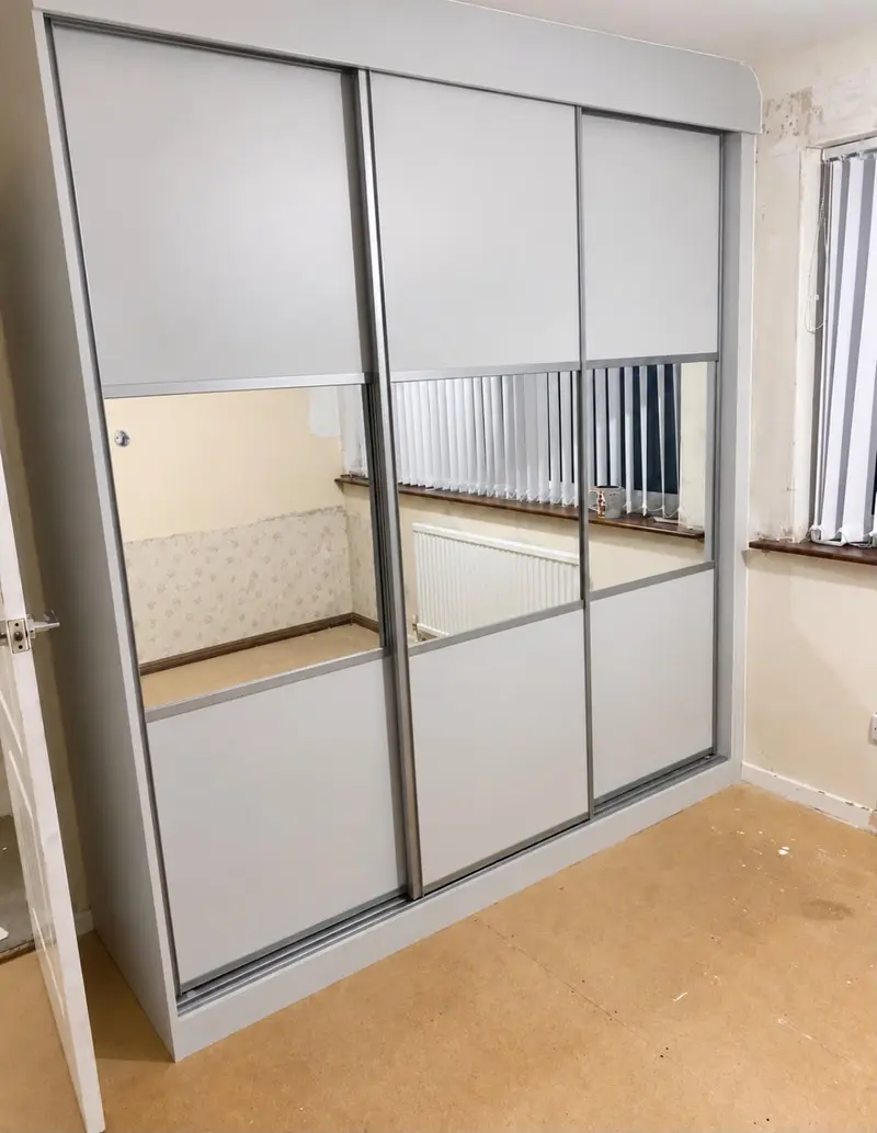 Split sliding wardrobe with mirrored panels