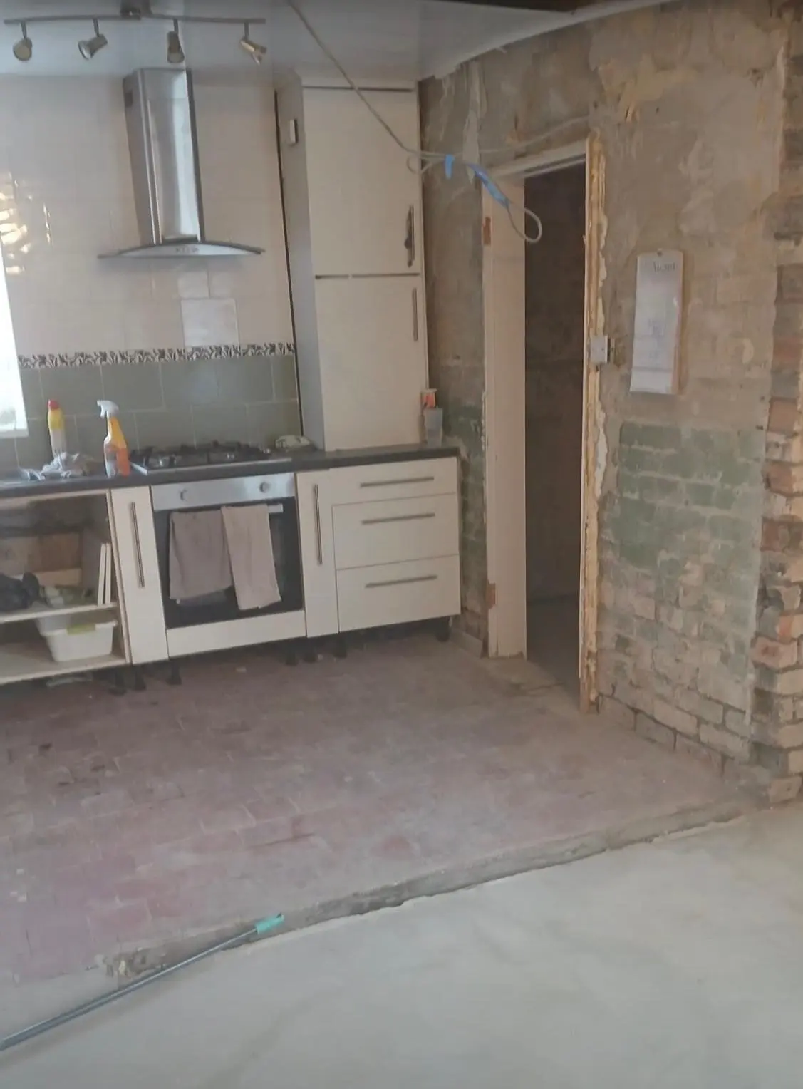 The old kitchen seen through the new opening, with the wall gone