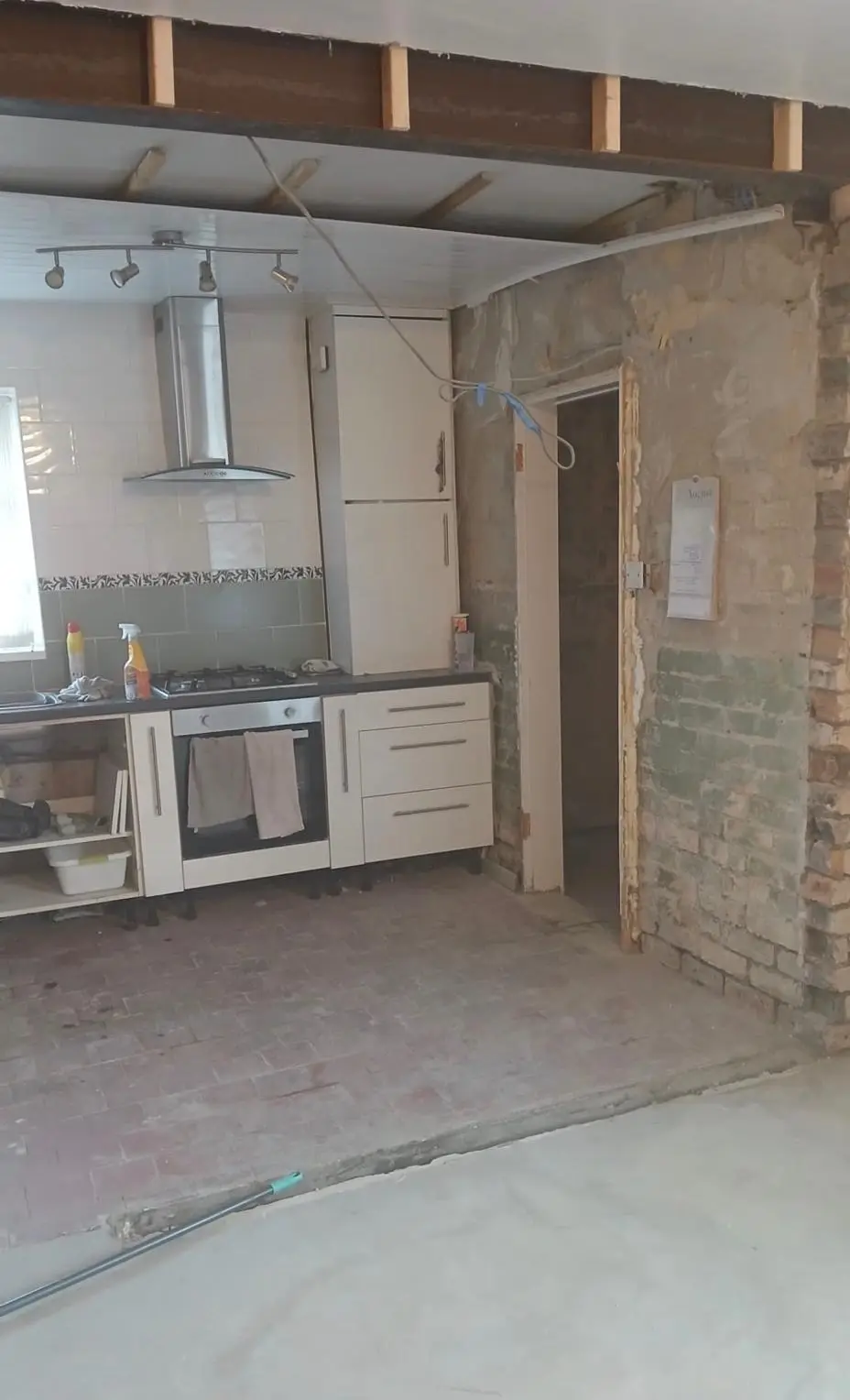 Looking through the opening to the old kitchen during the strip-out