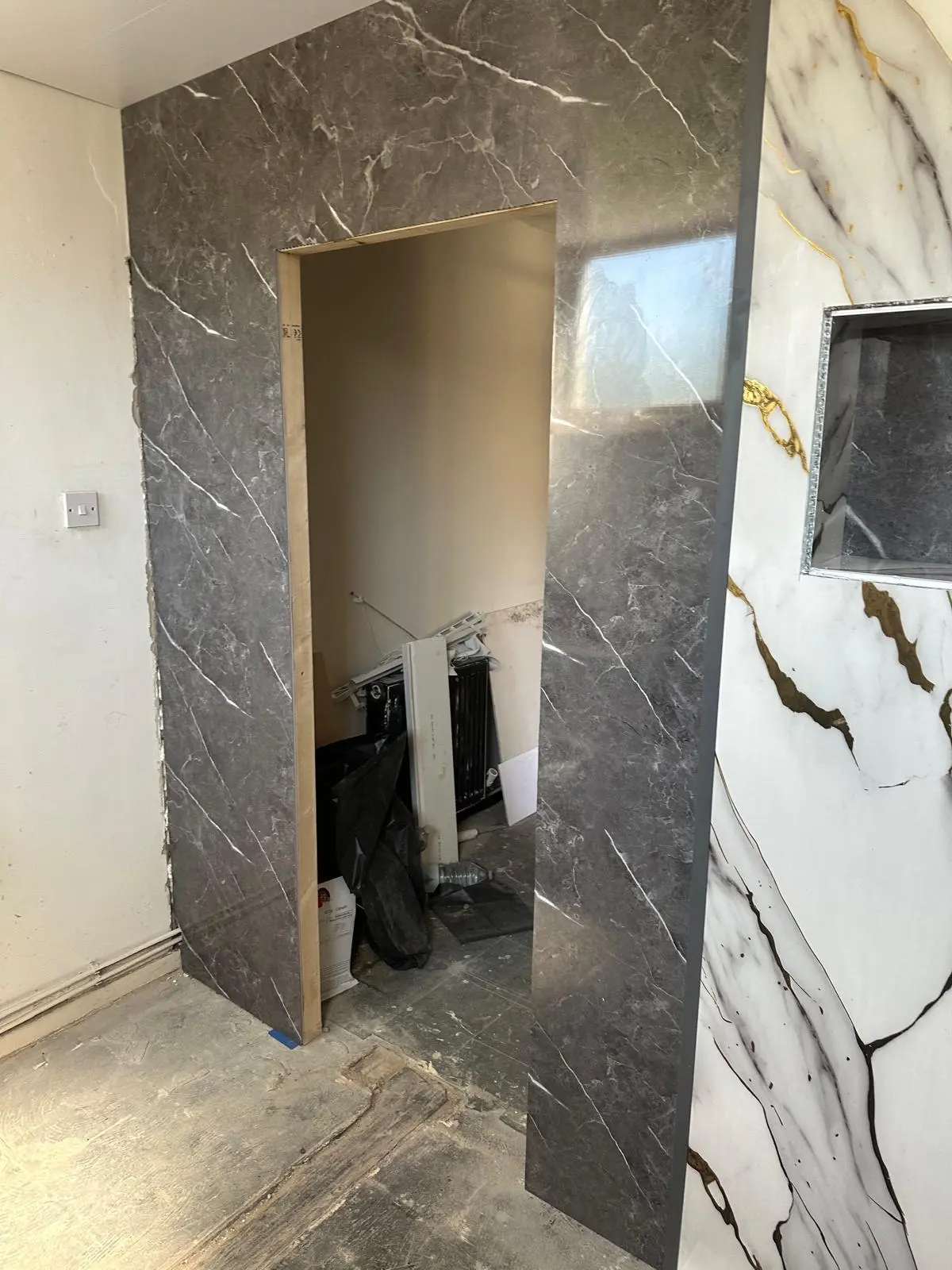 Marble-effect wall panels going up around the doorway