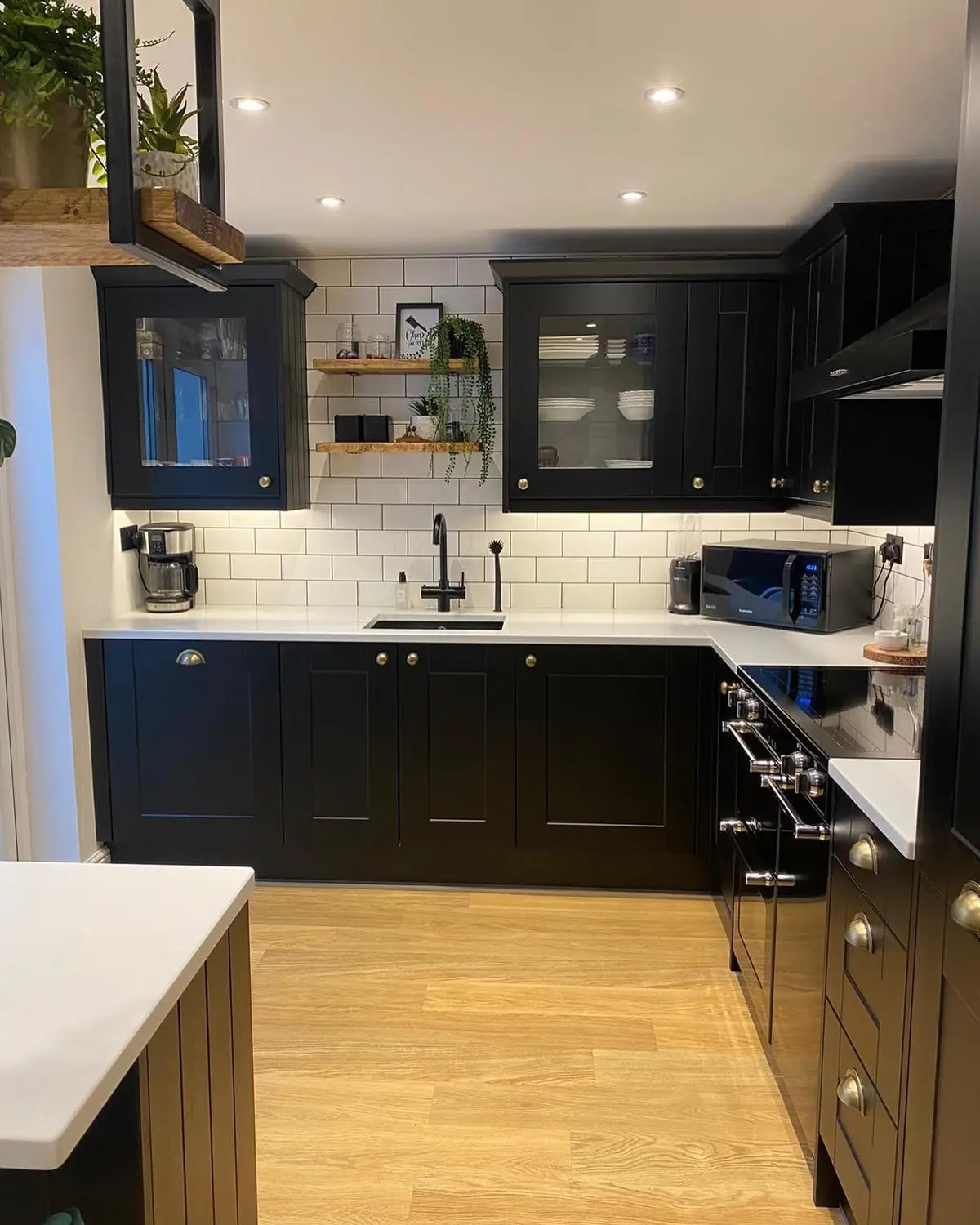 Matt black shaker kitchen with range cooker and white metro tiling