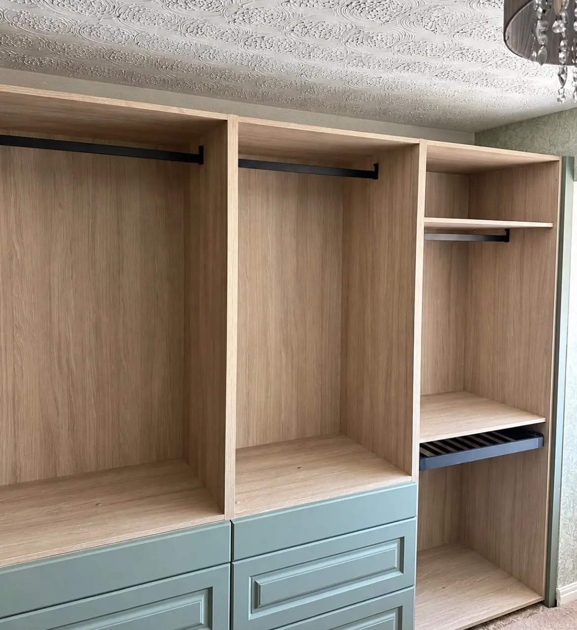Wardrobe carcasses with hanging rails and shelving during installation