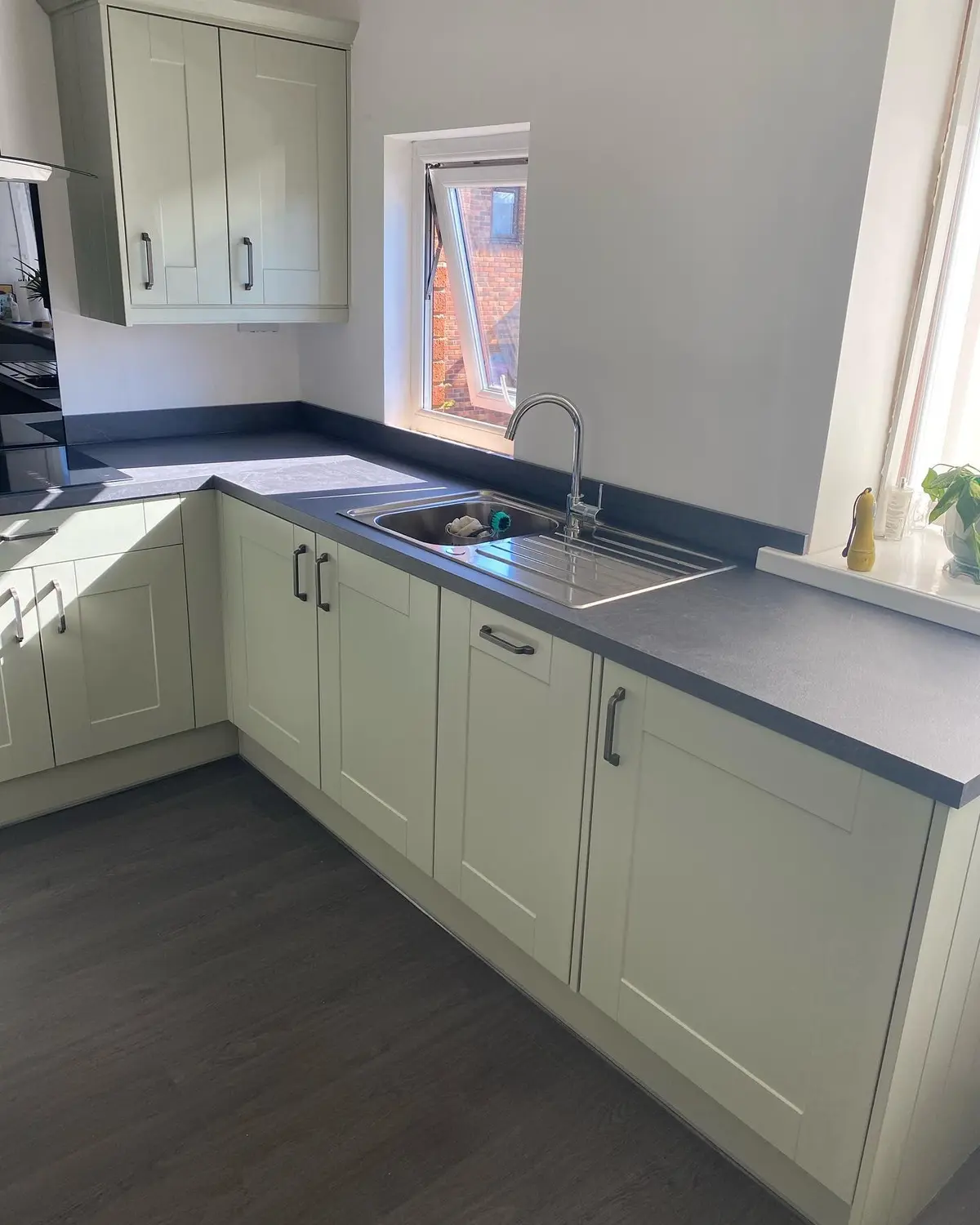 Sage shaker kitchen run seen from the doorway