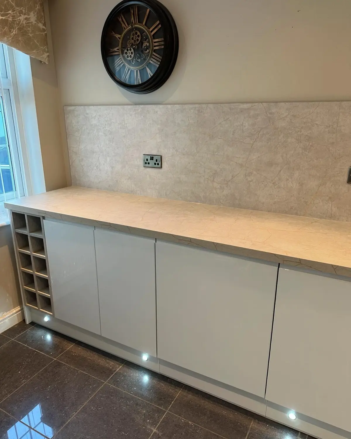 White gloss corner run with stone-effect worktop and wine rack